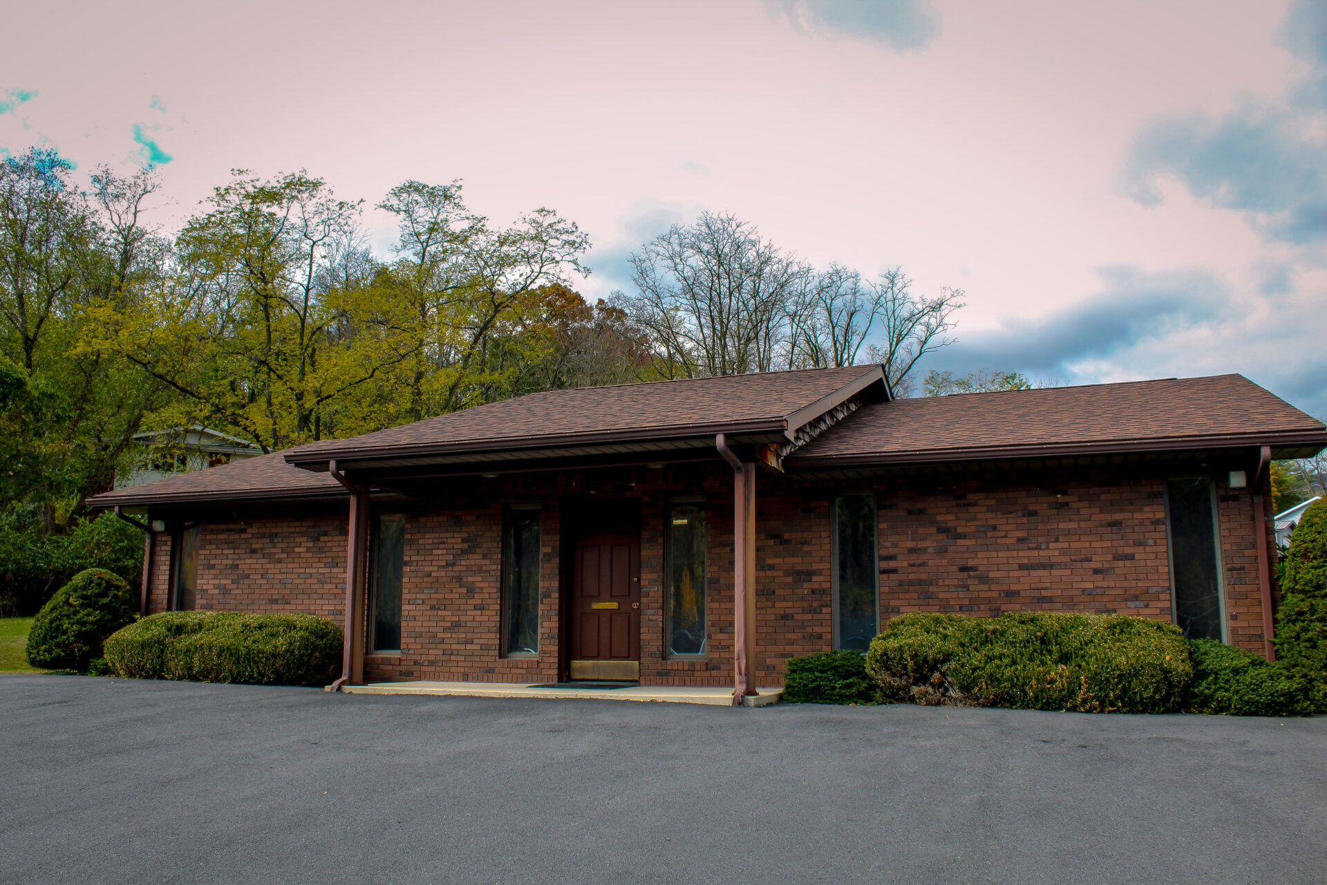 Modern brick office building with landscaped surroundings for Huber Michaels & Company.