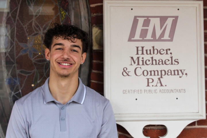 Friendly young man standing outside Huber Michaels & Company CPA office in Pennsylvania.